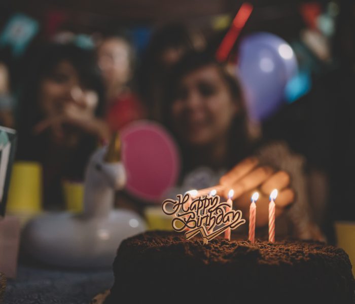 Group of friends celebrating a birthday in a hired party bus.